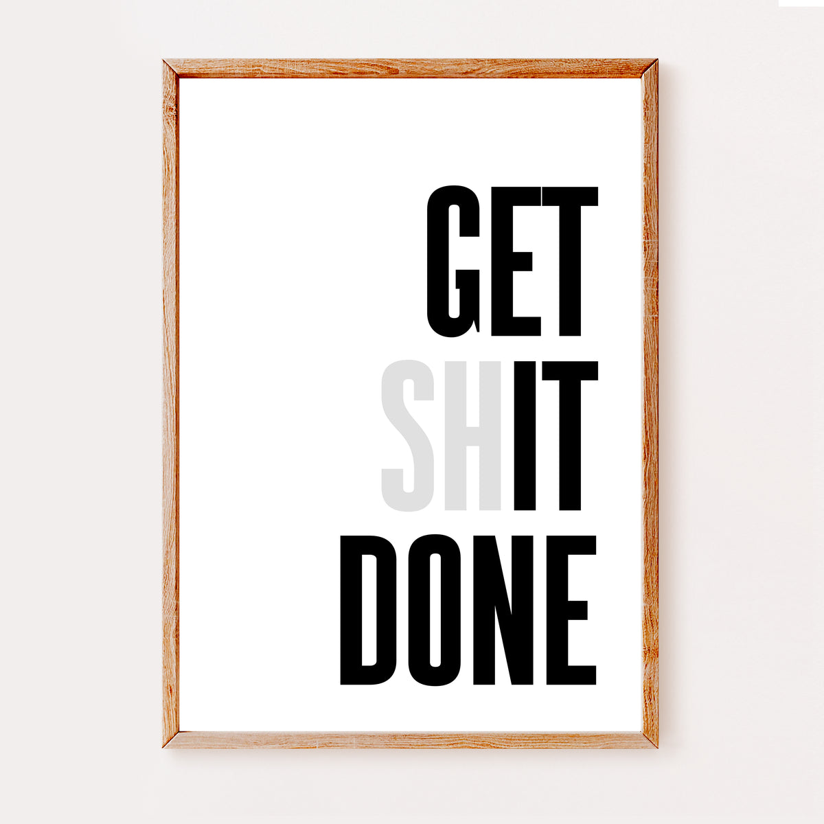A minimal office print in a bold black font that reads 'Get Shit Done' but with the 'SH' greyed out.