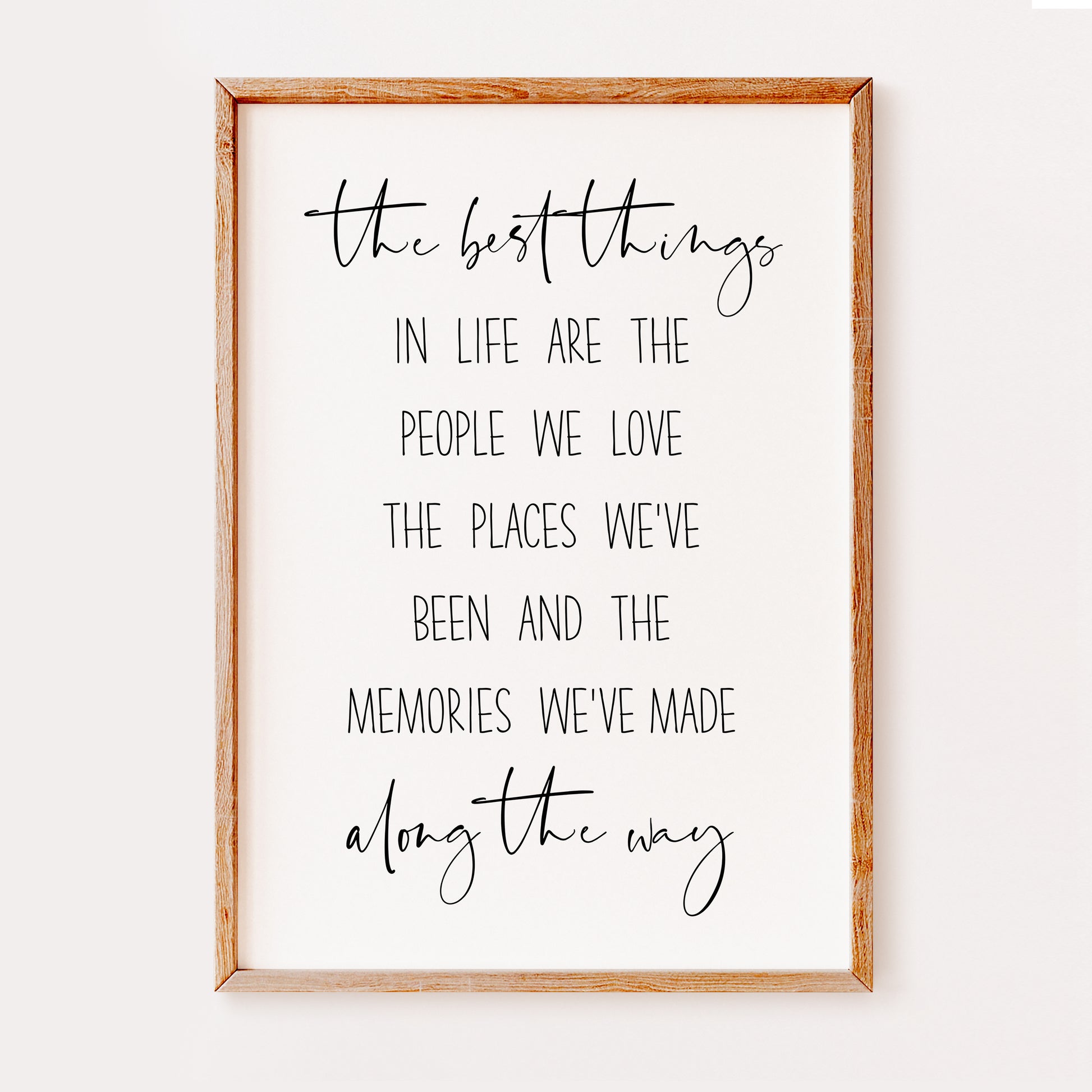 A heart warming quote print written in an elegant black font saying 'The best things in life are the people we love the places we've been and the memories we've made along the way'.