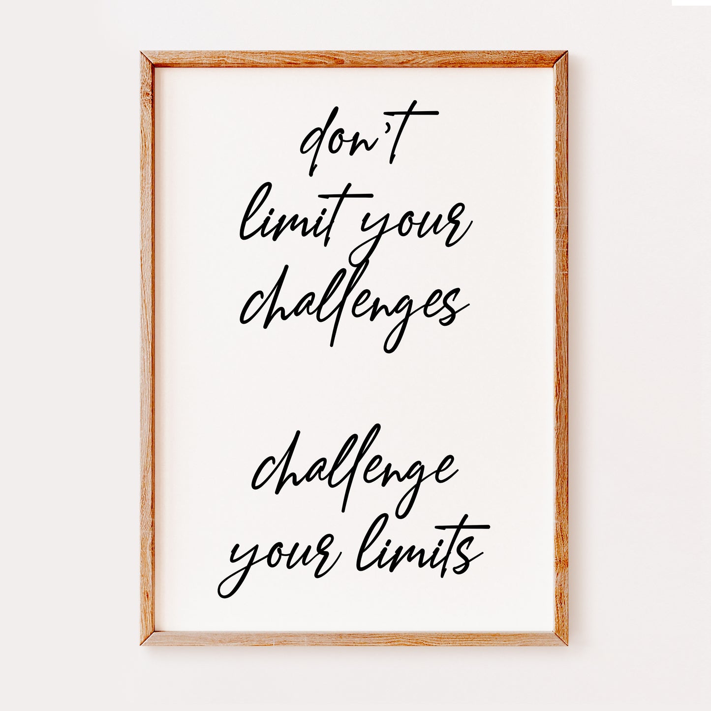 An inspirational quote saying 'dont limit your challenges, challenge your limits'. Written in a stylish black font set on a white background which makes this print a great addition to an office or work space.