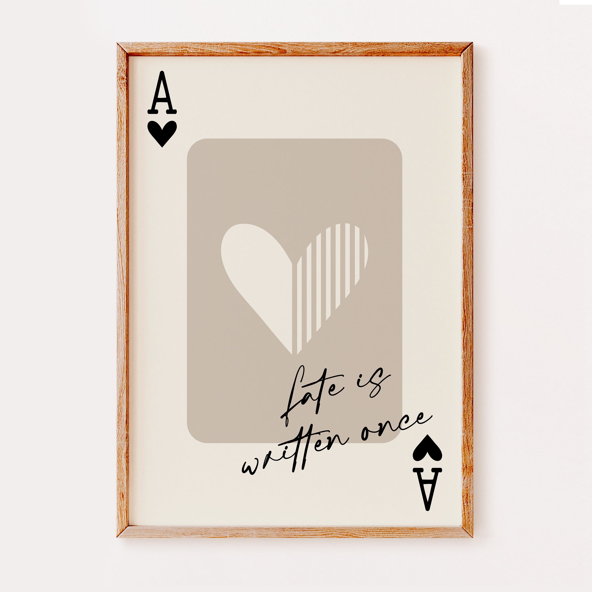 A popular wall art print illustrating an Ace of Hearts playing card in black and beige colours with the quote 'fate is written once' in a hand written black font.