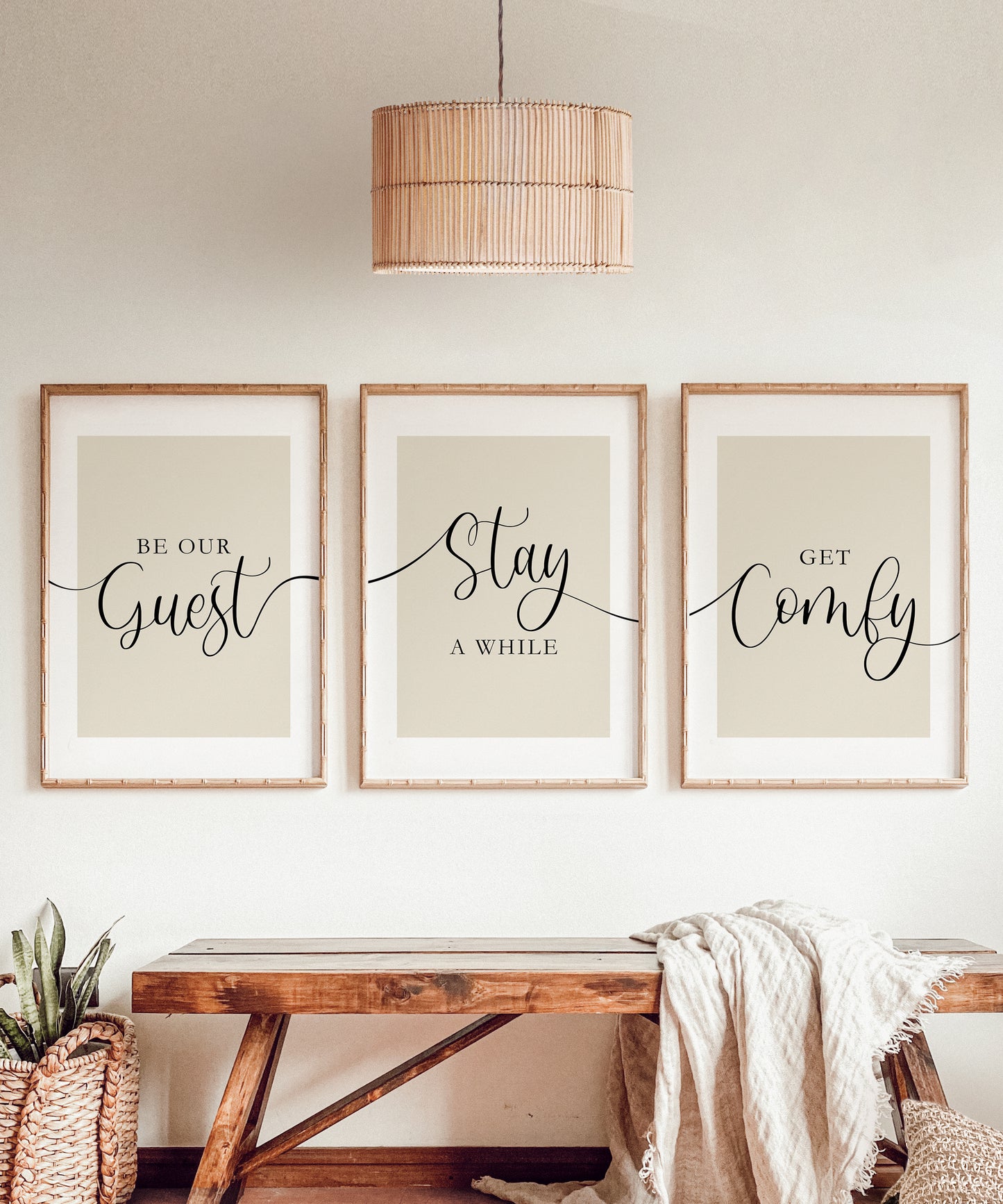 A perfect set of 3 guest room prints to add to a cosy bedroom or living room, which reads 'Be our guest, Stay a while, Get comfy' intertwined across a set of 3 prints with a beige background and an elegant black font.