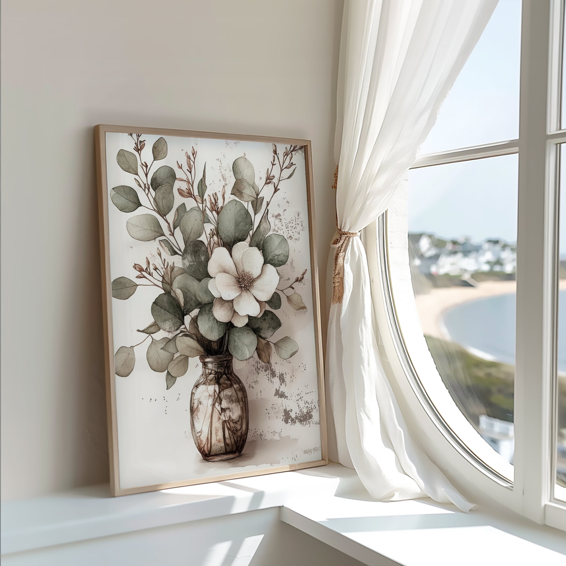 Framed floral artwork on a wall with a large window in the background