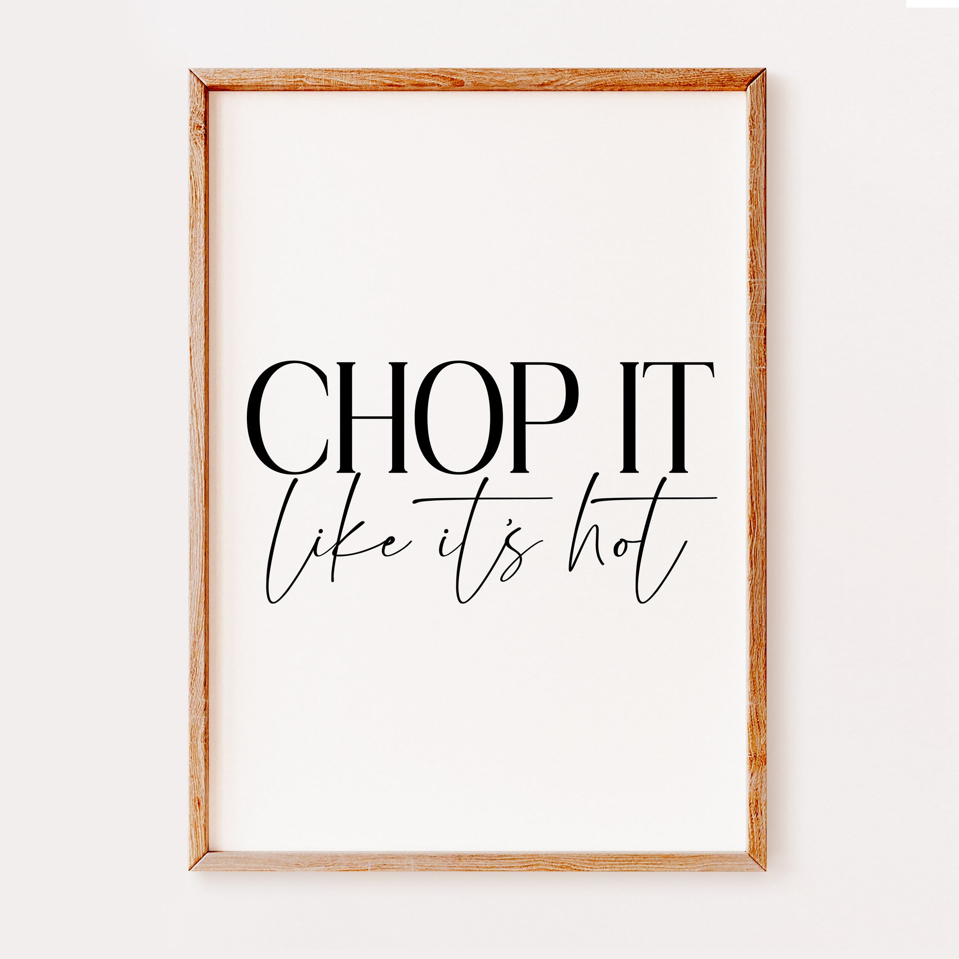 A typography kitchen print saying 'Chop it' in a large serif font with 'like its hot' in a stylish hand written  font underneath.
Set on a white background.