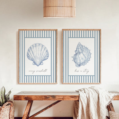Two framed prints of blue seashells with text on a wall above a wooden bench.