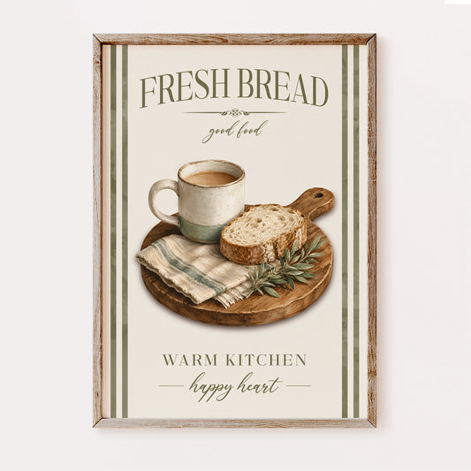 A framed kitchen wall art print featuring a rustic illustration of a mug of coffee and a slice of bread on a cutting board, with the text 'FRESH BREAD good food' and 'WARM KITCHEN happy heart'.