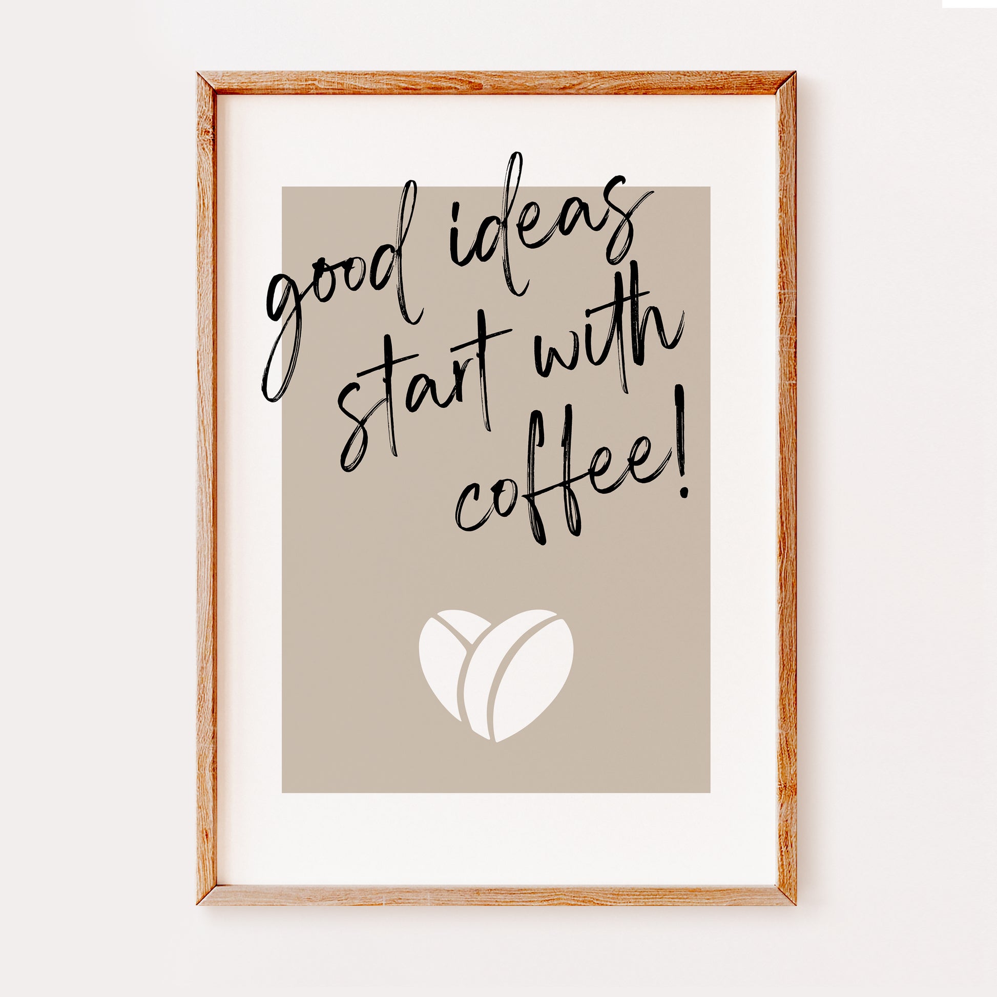 This stylish kitchen quote print features the quote 'good ideas star with coffee' in a stylish font with a coffee bean in the shape of a heart underneath.
The design is set on a dark beige background with a white border.