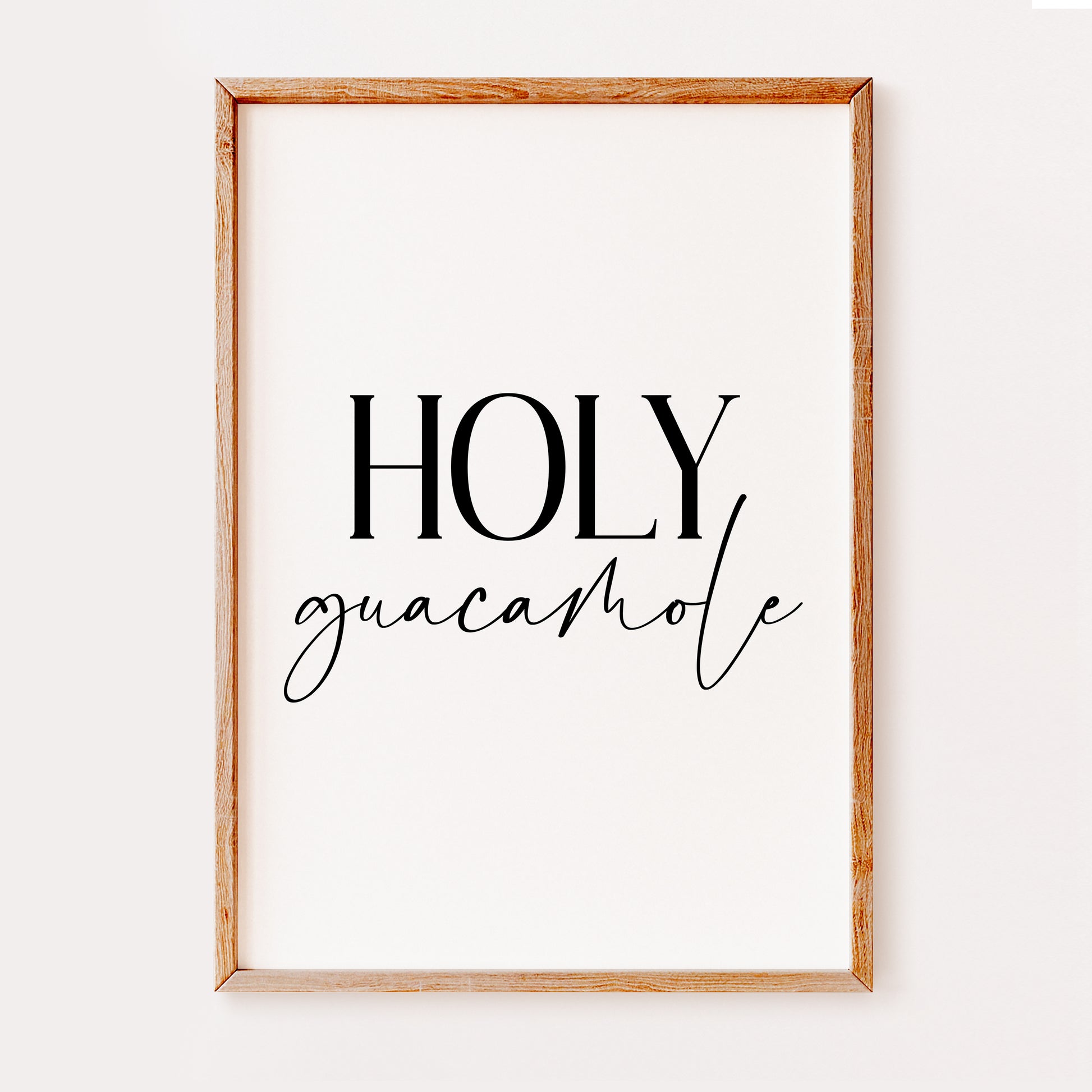 A fun kitchen typography print illustrating the quote 'Holy Guacamole' written in a stylish black font and set on a range of neutral background colours.