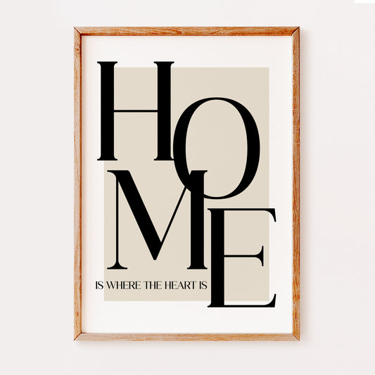 A typography print illustrating the quote 'Home is where the heart is'. Written in a large serif font against a beige background.