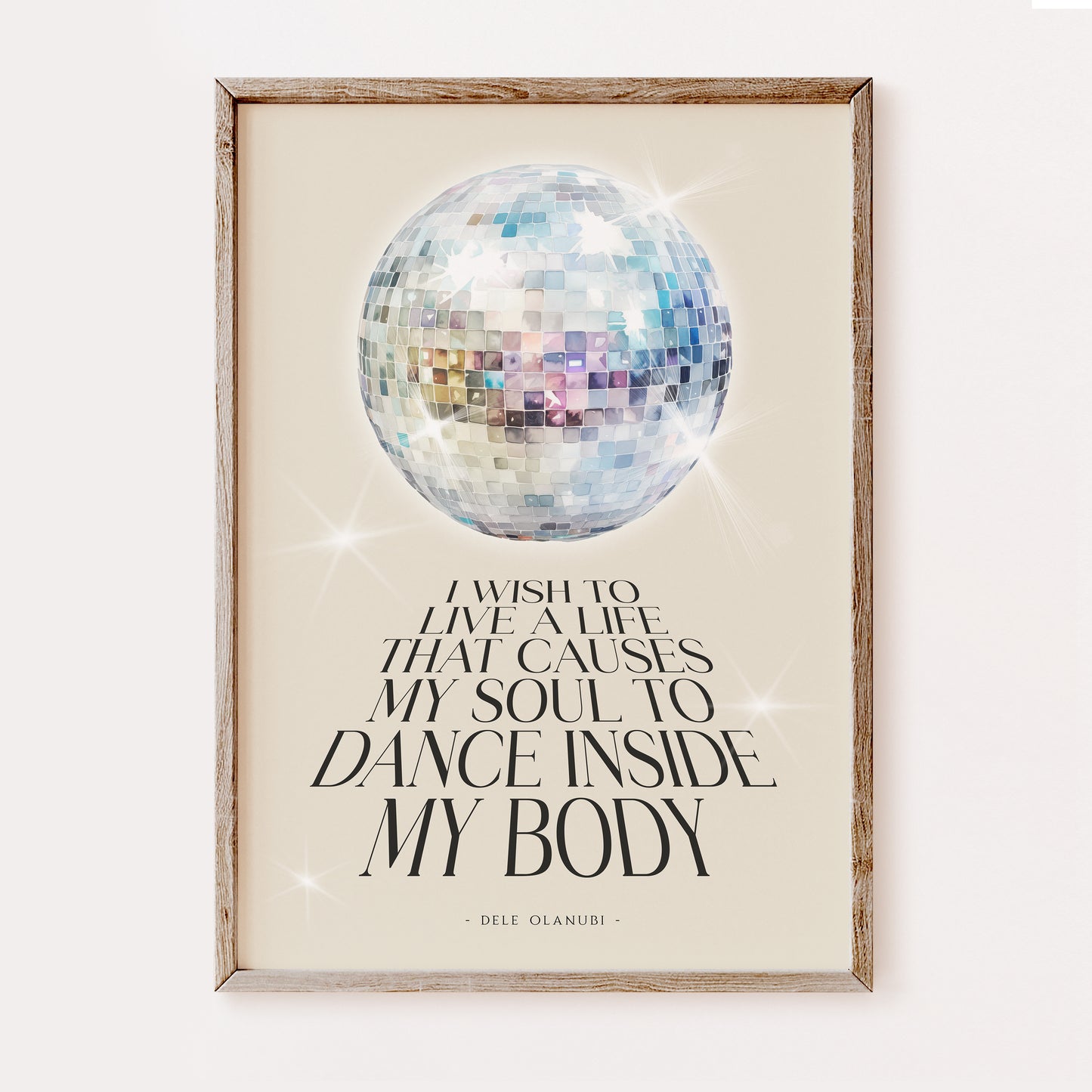 Framed artwork with a disco ball and inspirational quote reading 'I wish to live a life that causes my soul to dance inside my body' on a beige background