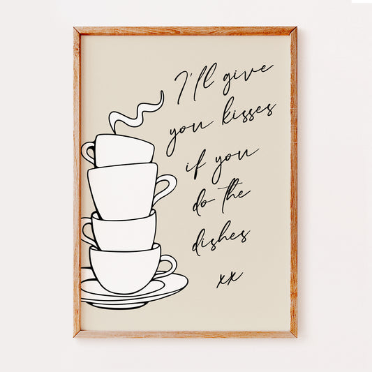 Framed wall art with a stack of coffee cups and text quote reading 'Ill give you kisses if you do the dishes' on a beige background