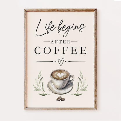 Framed wall art print with the phrase 'Life begins AFTER COFFEE' in black script and serif text, above a watercolor-style coffee cup with latte art, green leaves, and coffee beans, shown in a light wood frame against a plain light background.