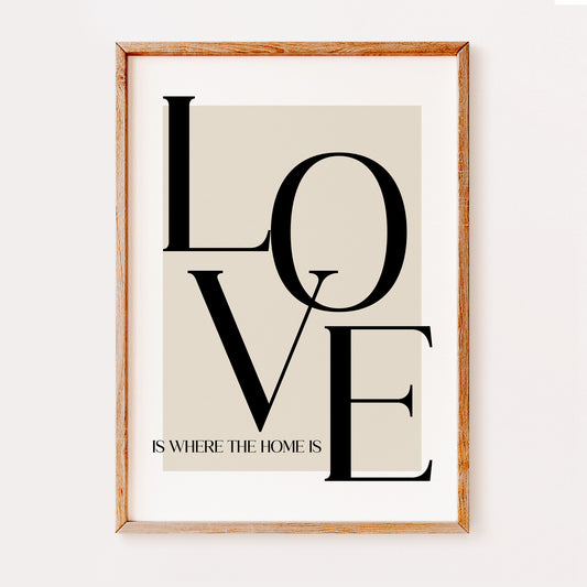 A typography print illustrating the quote 'Love is where the home is'. Written in a large serif font against a beige background.