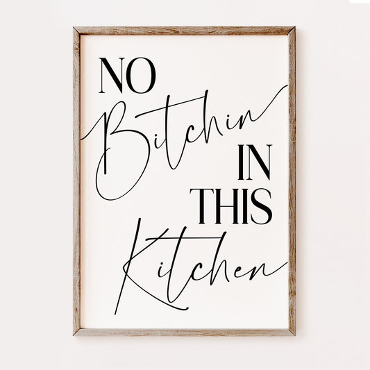 Framed wall art with text 'No Bitchin In This Kitchen' on a white background