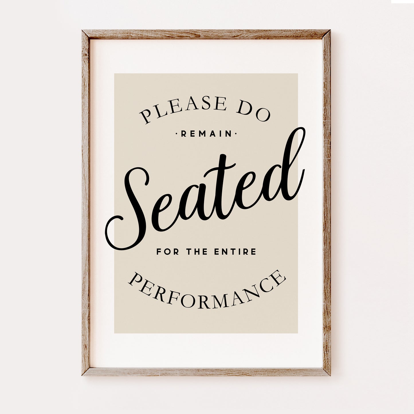 Funny minimalist bathroom wall art print with “Please Remain Seated for the Entire Performance” quote in black typography on a neutral beige background in a wooden frame.