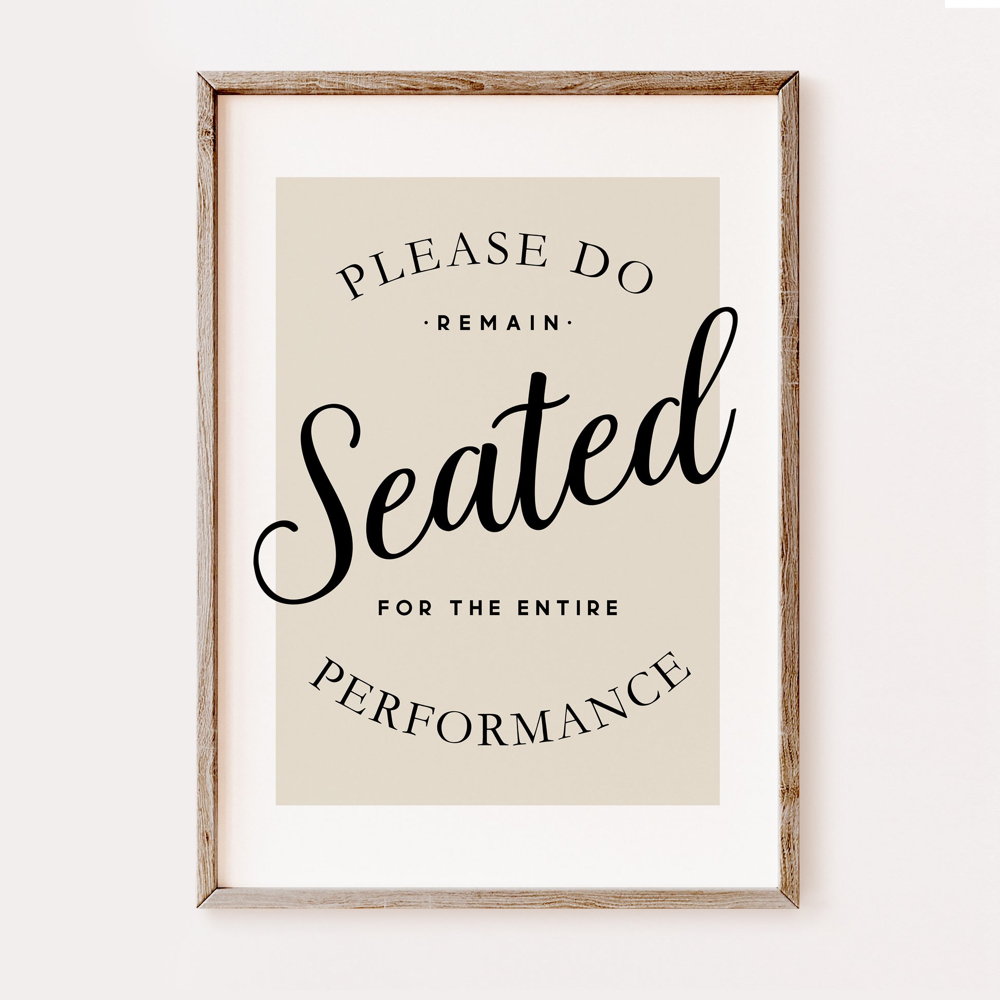 Funny minimalist bathroom wall art print with “Please Remain Seated for the Entire Performance” quote in black typography on a neutral beige background in a wooden frame.