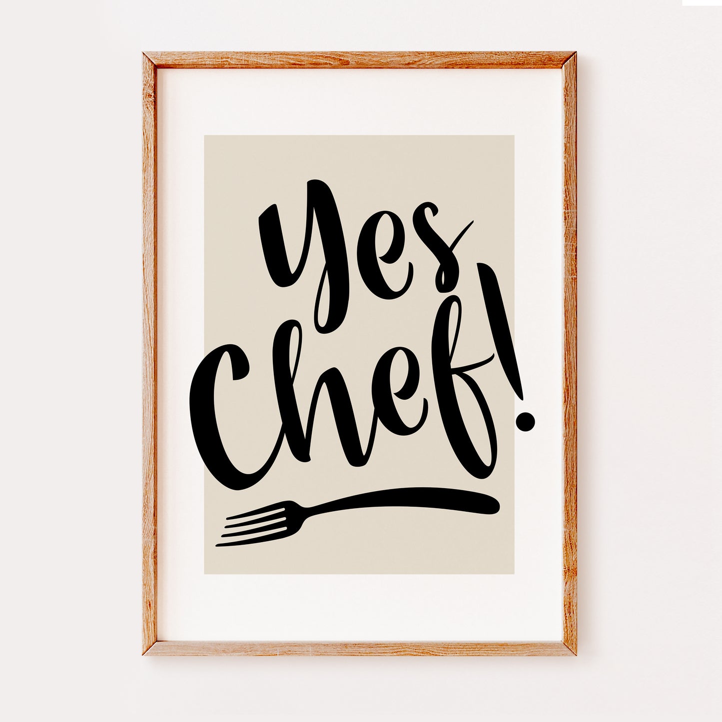 A fun typography kitchen print saying 'Yes Chef' in a stylish black font with a fork silhouette underneath.
Set on a beige background.