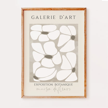 A boho print illustrating a bunch of petals in beige colours in an abstract style. Written above are the words 'galerie d'art' and written below are the words 'exposition botanique' and 'maison de fleurs', which gives this print a French feel.